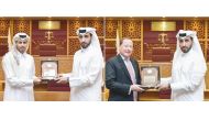 Faisal Al Sahouti, CEO of the Qatar International Court, presenting the awards to the officials of Omani & Partners Law Firm LLP and Sultan Al-Abdulla & Partners.