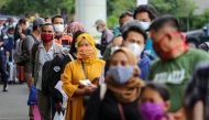 assengers wearing protective face masks line up for rapid antigen test at the Soekarno Hatta Airport, Tangerang, on the outskirts of Jakarta, Indonesia, December 22, 2020, in this photo taken by Antara Foto/Fauzan/via Reuters. 