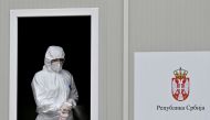 A medical worker disinfects the window of a testing booth while waiting for patients to test for coronavirus at the Institute of Virology, Vaccines and Sera “Torlak” in Belgrade on December 24, 2020. 