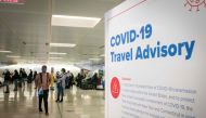 (FILES) In this file photo taken on November 21, 2020 travelers wait for their luggage at Newark International Airport in Newark, New Jersey. AFP / Kena Betancur