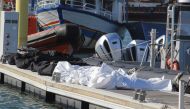 A picture taken at the port of Sfax in central Tunisia show the recovered bodies of 20 migrants from sub-Saharan Africa after their boat capsized at sea, on December 24, 2020. (AFP / HOUSSEM ZOUARI)