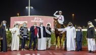 H H Sheikh Mohammed bin Khalifa Al Thani presenting the winner's trophy to representatives of Al Wasmiyah Farm after Noor Al Hawa (FR) won the Gr2 Trophy race for 3YO+ Thoroughbreds yesterday. 