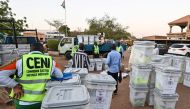Members of Niger's Independent National Electoral Commission (CENI) load ballot boxes and election equipment onto a truck on December 26, 2020, in Niamey, on the eve of the country's presidential and legislative elections. / AFP / Issouf SANOGO