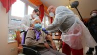 Edith Kwoizalla, 101 years old, receives the first vaccination against the novel coronavirus COVID-19 by Pfizer and BioNTech from Doctor Bernhard Ellendt (R) in a senior care facility in Halberstadt (Seniorenzentrum Krueger), central northern Germany, on 