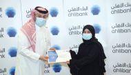 Ahlibank CEO, Hassan AlEfrangi honouring a long-serving employee.