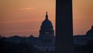 The U.S. Capitol Building is seen past the Washington Monument as the sun rises on December 27, 2020 in Washington, DC. Samuel Corum/Getty Images/AFP