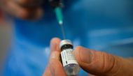A member of the medical staff prepares a dose of the Pfizer/BioNtech COVID-19 vaccine at the Notre-Dame hospital in Brussels, for Belgian patient Lucie Danjou, 101, on December 28, 2020 as the country starts its national vaccination campaign to fight agai