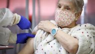 An elderly woman receives an injection with a dose of Pfizer-BioNTech Covid-19 vaccine at Vallecas nursing home, as the coronavirus disease (COVID-19) outbreak continues, in Madrid, Spain December 27, 2020. Comunidad de Madrid/Handout via Reuters