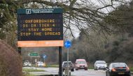 Vehicles drive past a roadside public health information sign, amidst the spread of the coronavirus disease (COVID-19) pandemic, near Oxford, Britain, December 28, 2020. REUTERS/Toby Melville
