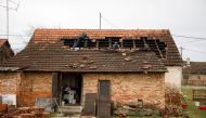People repair the roof of a damaged house after a 5.2 magnitude earthquake, in Brest Pokupski village, Croatia, December 28, 2020. REUTERS/Antonio Bronic