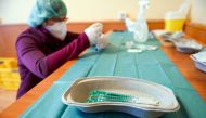 Pharmacist Susanne Wohlgemuth prepares Pfizer/BioNTech COVID-19 vaccinations at the Haus an der Linde nursing home in Lichtentanne, Saxony, Germany December 27, 2020, the day when the country starts its vaccination programme. Hendrik Schmidt/Pool via Reut