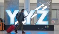 FILE PHOTO: A traveller passes a YYZ airport code sign in the international arrival lounge amid a growing global number of coronavirus cases at Pearson Airport in Toronto, Ontario, Canada March 13, 2020. REUTERS/Chris Helgren
