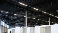 An employee walks past portacabins in the Expo Houten, in Houten on December 30, 2020, as part of the locations setting-up for the Dutch national Covid-19 vaccination campaign to fight against the spread of the novel coronavirus. / AFP / ANP / Sem van der