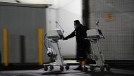 A hospital worker pushes two Computer on Wheels (COW) workstations outside the emergency room at the Community Hospital of Huntington Park during a surge in positive coronavirus cases in Huntington Park, California, U.S. December 29, 2020. REUTERS/Bing Gu