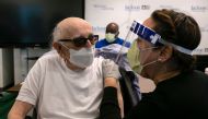 Norman G. Einspruch, 88, a cardiology patient at Jackson Memorial Hospital, talks with a nurse after receiving a Pfizer-BioNtech Covid-19 vaccine at Christine E. Lynn Rehabilitation Center, in Miami, Florida on December 30, 2020. / AFP / Eva Marie UZCATEG