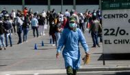 Health workers queue to receive the Pfizer/BioNTech COVID-19 vaccine jab, at the 22 Battalion of the Military Police Hospital in Mexico City, on December 30, 2020. Mexico has registered more than 124,000 coronavirus deaths -- the world's fourth-highest to