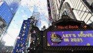 People play with confetti as New Year's Eve organizers test the air worthiness of confetti from the Hard Rock Cafe Marquee in Times Square on December 29, 2020 in New York City. The 2,000 pounds of confetti (907 kilograms) released on New Year’s Eve will 