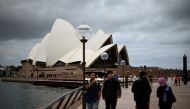 People visit the Opera House in Sydney on December 30, 2020, as authorities work to suppress a growing cluster of Covid-19 coronavirus cases in Australia's most populous city. / AFP / Saeed KHAN
