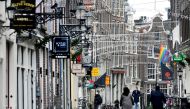 FILE PHOTO: People ride bikes on an empty street as Netherlands has gone into lockdown as the spread of the coronavirus disease (COVID-19) continues in Amsterdam, Netherlands December 15 2020, REUTERS/Piroschka van de Wouw