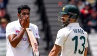 TOPSHOT - India's Ravi Ashwin (L) reacts after nearly dismissing Australia's Matthew Wade (R) on the third day of the second cricket Test match between Australia and India played at the MCG in Melbourne on December 28, 2020. / AFP / WILLIAM WEST /