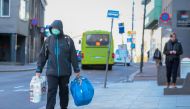 FILE PHOTO: A man wearing a protective mask carries shopping bags as he walks on the streets of Oslo following an outbreak of the coronavirus disease (COVID-19), in Oslo, Norway March 13, 2020. NTB Scanpix/Hakon Mosvold Larsen via REUTERS .

