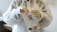 FILE PHOTO: A health worker holds a COVID-19 sample collection kit of a vaccine trials' volunteer, after they were tested for the coronavirus disease and take part in the country's human clinical trial for potential vaccines at the Wits RHI Shandukani Res