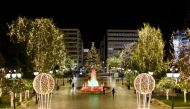 People make their way on the Christmas-decorated Syntagma square before New Year's day celebrations, amid the coronavirus disease (COVID-19) pandemic in Athens, Greece, December 31, 2020. Picture taken December 31, 2020. REUTERS/Louiza Vradi
