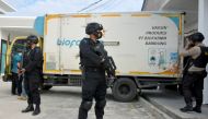 Armed police officers stand guard next to a truck containing Sinovac's vaccine for coronavirus disease (COVID-19) during its distribution in Pekanbaru, Riau province, Indonesia, January 5, 2021 in this photo taken by Antara Foto. Antara Foto/FB Anggoro vi