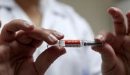 A nurse holds a dose of China's CoronaVac, a potential vaccine against the coronavirus disease (COVID-19) before administering it to a volunteer at Emilio Ribas Institute in Sao Paulo, Brazil July 30, 2020. Picture taken July 30, 2020. REUTERS/Amanda Pero