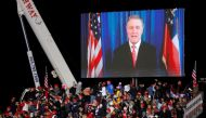 Republican US Senator David Perdue appears in a video as US President Donald Trump campaigns with Republican US Senator Kelly Loeffler on the eve of Georgia's run-off election in Dalton, Georgia, US, January 4, 2021. Reuters/Brian Snyder