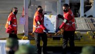 Workers unload a box with Pfizer/BioNTech COVID-19 vaccines to be transported to Saltillo, at the Mariano Escobedo International Airport, as the coronavirus disease (COVID-19) outbreak continues, in Apodaca, on the outskirts of Monterrey, Mexico January 5