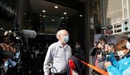 American lawyer John Clancey walks out of a building as he is taken away by police officers in Hong Kong, China January 6, 2021. Reuters/Lam Yik
