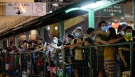 People wearing face masks and face shields as protection against the coronavirus disease (Covid-19) queue at a bus stop, in Quezon City, Metro Manila, Philippines, December 23, 2020. Reuters/Lisa Marie David/File Photo