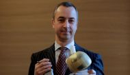 Carmat Chief Executive Officer Stephane Piat holds an artificial heart as he poses after the company's news conference in Paris, France, February 14, 2017. Reuters/Christian Hartmann/File Photo