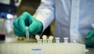 An employee of the German biopharmaceutical company CureVac demonstrates research workflow on a vaccine for the coronavirus (COVID-19) disease at a laboratory in Tuebingen, Germany, March 12, 2020. Reuters/Andreas Gebert/File Photo