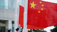 Members of the Hong Kong Police Honour Guard raise flags during a flag-raising ceremony marking China's National Day in Hong Kong, China October 1, 2020. Reuters/Lam Yik/File Photo