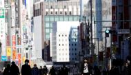 Pedestrians wearing protective masks, amid the coronavirus disease (COVID-19) outbreak, make their way at Ginza shopping district which closed to cars on Sunday in Tokyo, Japan, January 10, 2021. REUTERS/Kim Kyung-Hoon