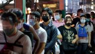 FILE PHOTO: People wearing face masks and face shields as protection against the coronavirus disease (COVID-19) queue at a bus stop, in Quezon City, Metro Manila, Philippines, December 23, 2020. REUTERS/Lisa Marie David/File Photo

