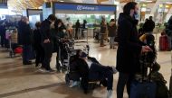 Stranded passengers wait for news about their flights at Adolfo Suarez Barajas airport, which is suspending flights due to heavy snowfall in Madrid, Spain, January 9, 2021. REUTERS/Susana Vera
