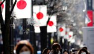 Pedestrians wearing protective masks, amid the coronavirus disease (COVID-19) outbreak, make their way at Ginza shopping district which closed to cars on Sunday in Tokyo, Japan, January 10, 2021. REUTERS/Kim Kyung-Hoon