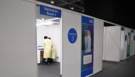 Members of the staff work at a NHS mass coronavirus vaccination centre in the Excel Centre in London, Britain January 11, 2021. Jeremy Selwyn/Pool via REUTERS