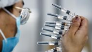 FILE PHOTO: A worker performs a quality check in the packaging facility of Chinese vaccine maker Sinovac Biotech, developing an experimental coronavirus disease (COVID-19) vaccine, during a government-organized media tour in Beijing, China, September 24, 