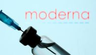 A vial and sryinge are seen in front of a displayed Moderna logo in this illustration taken January 11, 2021. REUTERS/Dado Ruvic/Illustration
