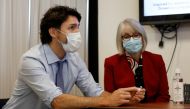 Canada's Prime Minister Justin Trudeau, with Minister of Health Patty Hajdu, holds an empty COVID-19 vaccine vial after the first vaccinations were given at the Civic Hospital in Ottawa, Ontario, Canada December 15, 2020. REUTERS/Blair Gable/File Photo