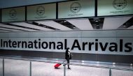 FILE PHOTO: A traveller wearing a face mask walks at the Terminal 5 at Heathrow Airport, as the spread of the coronavirus disease (COVID-19) continues, in London, Britain, July 26, 2020. REUTERS/Henry Nicholls
