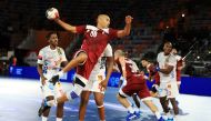 Qatar’s Mahmoud Hassaballa prepares to shoot at the goal during the 2021 IHF Handball World Championship   Preliminary Round Group C match against Angola yesterday.
