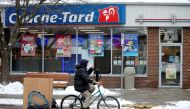 A man cycles past a Couche-Tard convenience store in Montreal, Quebec, Canada January 13, 2021. Reuters/Christinne Muschi/File Photo