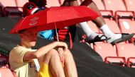 Arsenal's Mesut Ozil sits under an umbrella as he shields from the sun on the bench, as play resumes behind closed doors following the outbreak of the coronavirus disease (COVID-19) Andrew Matthews