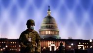 FILE PHOTO: Members of the National Guard gather at the U.S. Capitol as the House of Representatives prepares to begin the voting process on a resolution demanding U.S. Vice President Pence and the cabinet remove President Trump from office, in Washington