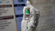 A paramedic fills a syringe with COVISHIELD, a COVID-19 vaccine manufactured by Serum Institute of India, before administering it to a colleague during one of the world's largest COVID-19 vaccination campaigns at a health centre in Ahmedabad, India, Janua